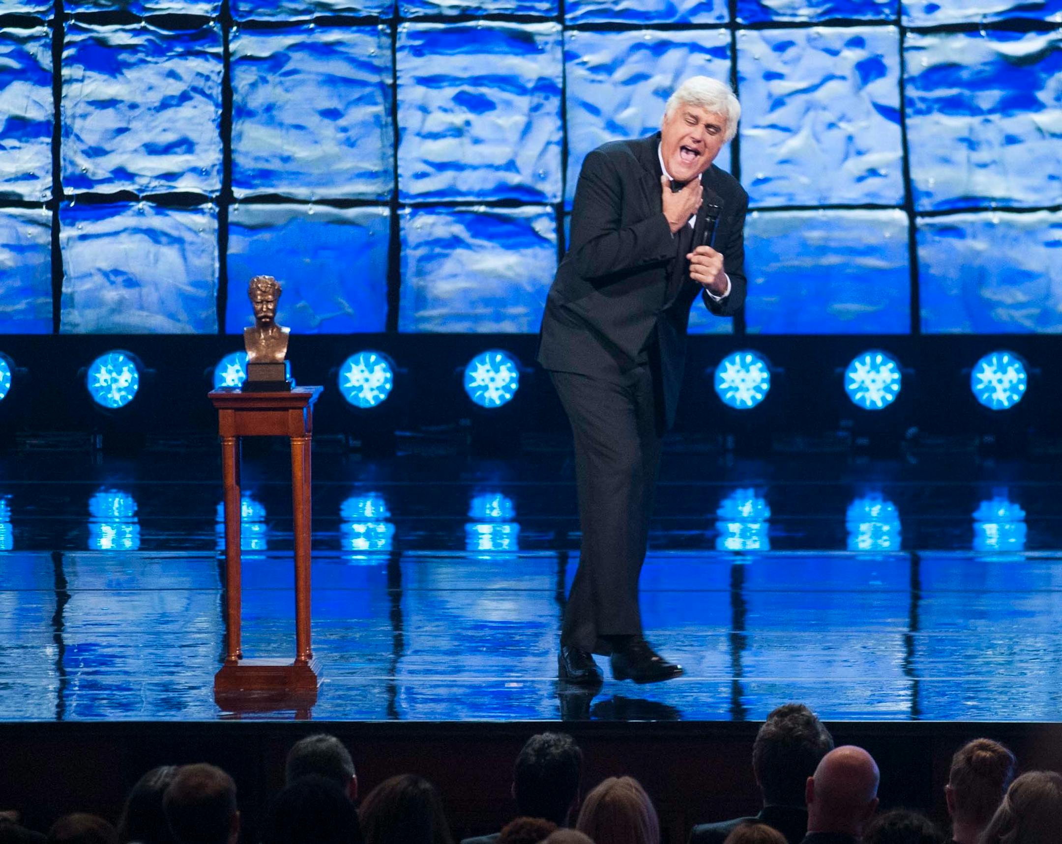 Mark Twain Prize honoree Jay Leno tells jokes after being presented with the prize at the Kennedy Center for the Performing Arts for the Mark Twain Prize for American Humor on Sunday, Oct. 19, 2014, in Washington. (AP Photo/Kevin Wolf)