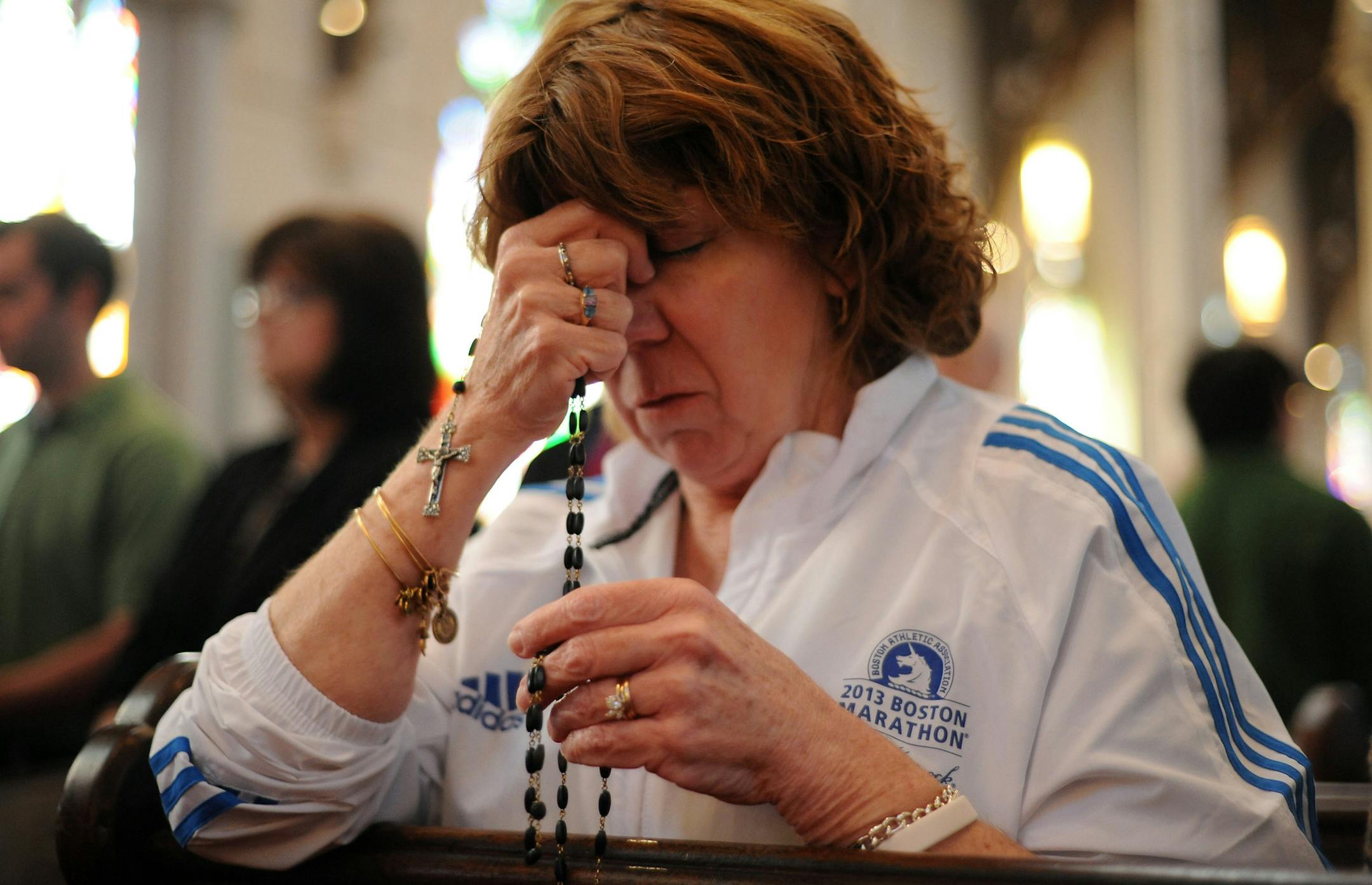 Nurse practitioner Maureen Quaranto, a first-year marathon volunteer who worked in Tent A during the explosions at the Boston Marathon, attends Mass at the Cathedral of the Holy Cross in Boston, on Sunday April 21, 2013. (AP Photo/Boston Herald, Faith Ninivaggi)