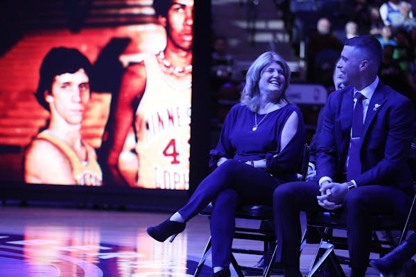 Debbie Saunders and son Ryan shared a laugh during a pregame ceremony honoring the late Flip Saunders in 2018. This weekend, a high school gym in his 