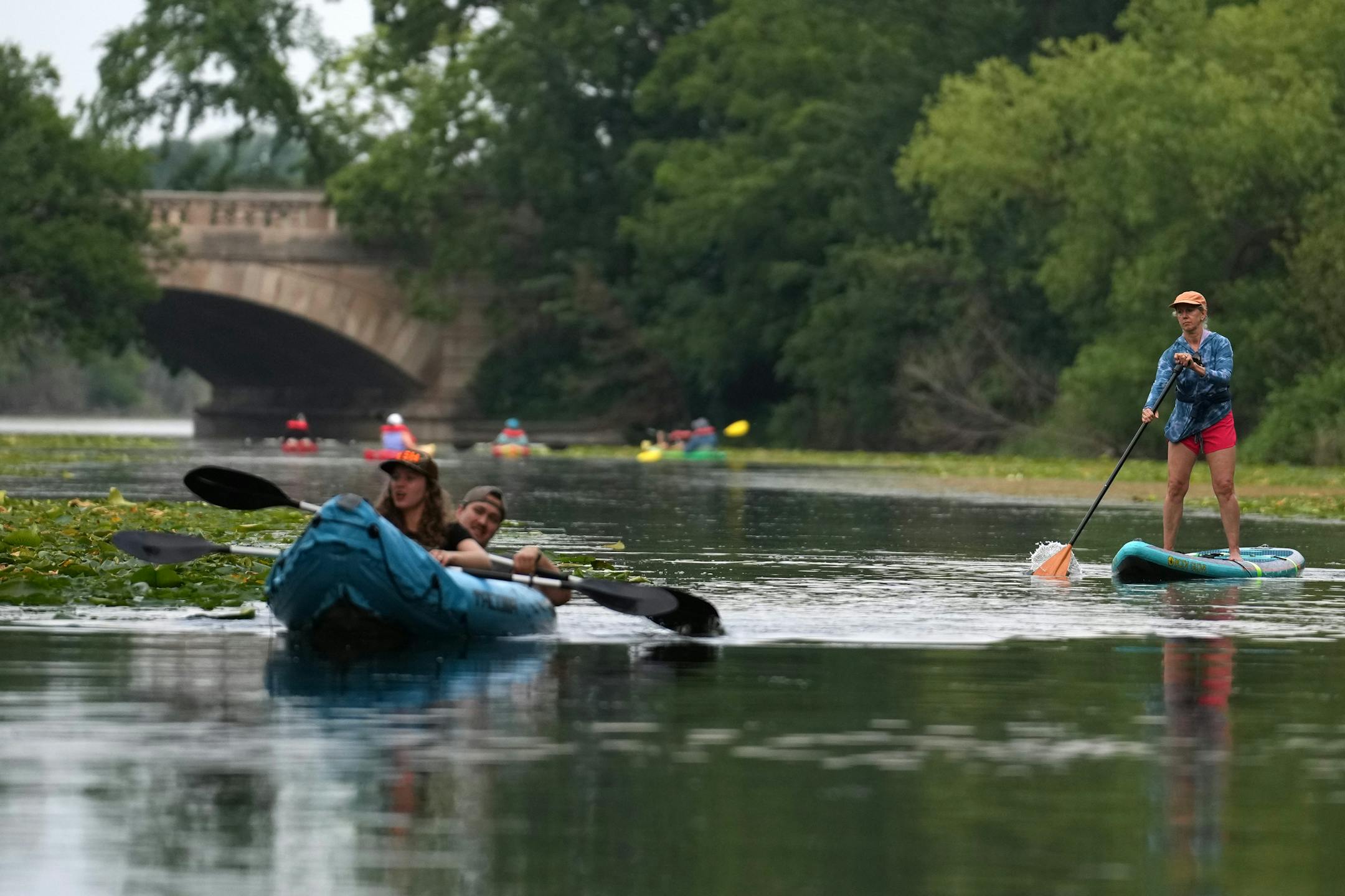 Groups paddle down the Cedar Lake Canal, which connects Cedar Lake with Lake of the Isles, on Sunday, Aug. 3, 2025, in Minneapolis.