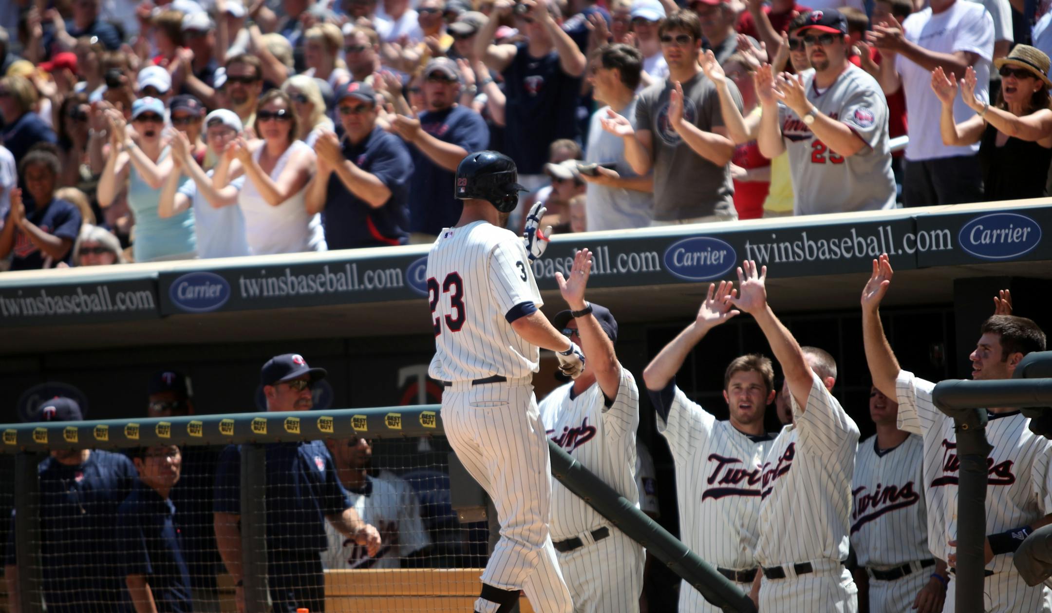 Rene Tosoni (23) celebrated with his Twins teammates after hitting a three-run home run to right-center in the fourth inning against the Brewers on Sunday, cutting Milwaukee's lead to 6-4 in an eventual 9-7 victory.