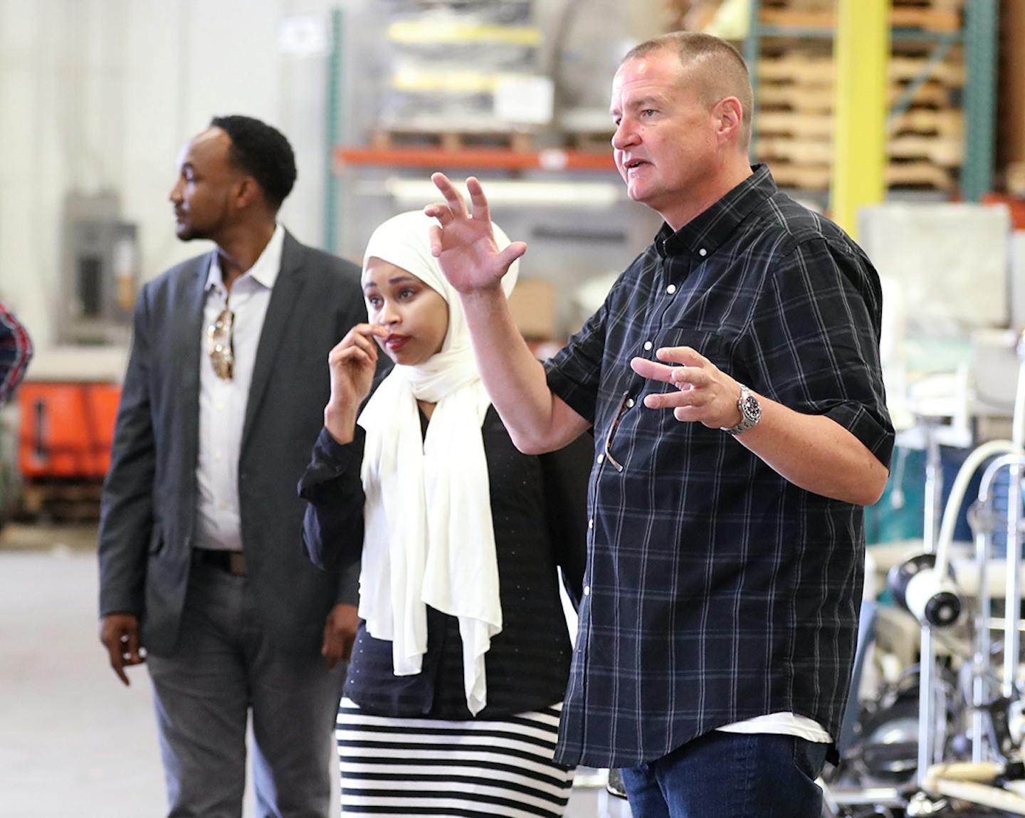 MATTER vice president of procurement & international programs Mike Muelken, center, talks with representatives from the nonprofit MN Community of African People with Disabilities, Hassan Ali, from right, Nimo Ahmed and Mahad Hassan at the MATTER headquarters in St. Louis Park. ] (Leila Navidi/Star Tribune) leila.navidi@startribune.com BACKGROUND INFORMATION: Monday, June 13, 2016 in St. Louis Park. The Minnesota nonprofit, MATTER, joined forces with the Minnesota Community of African People With