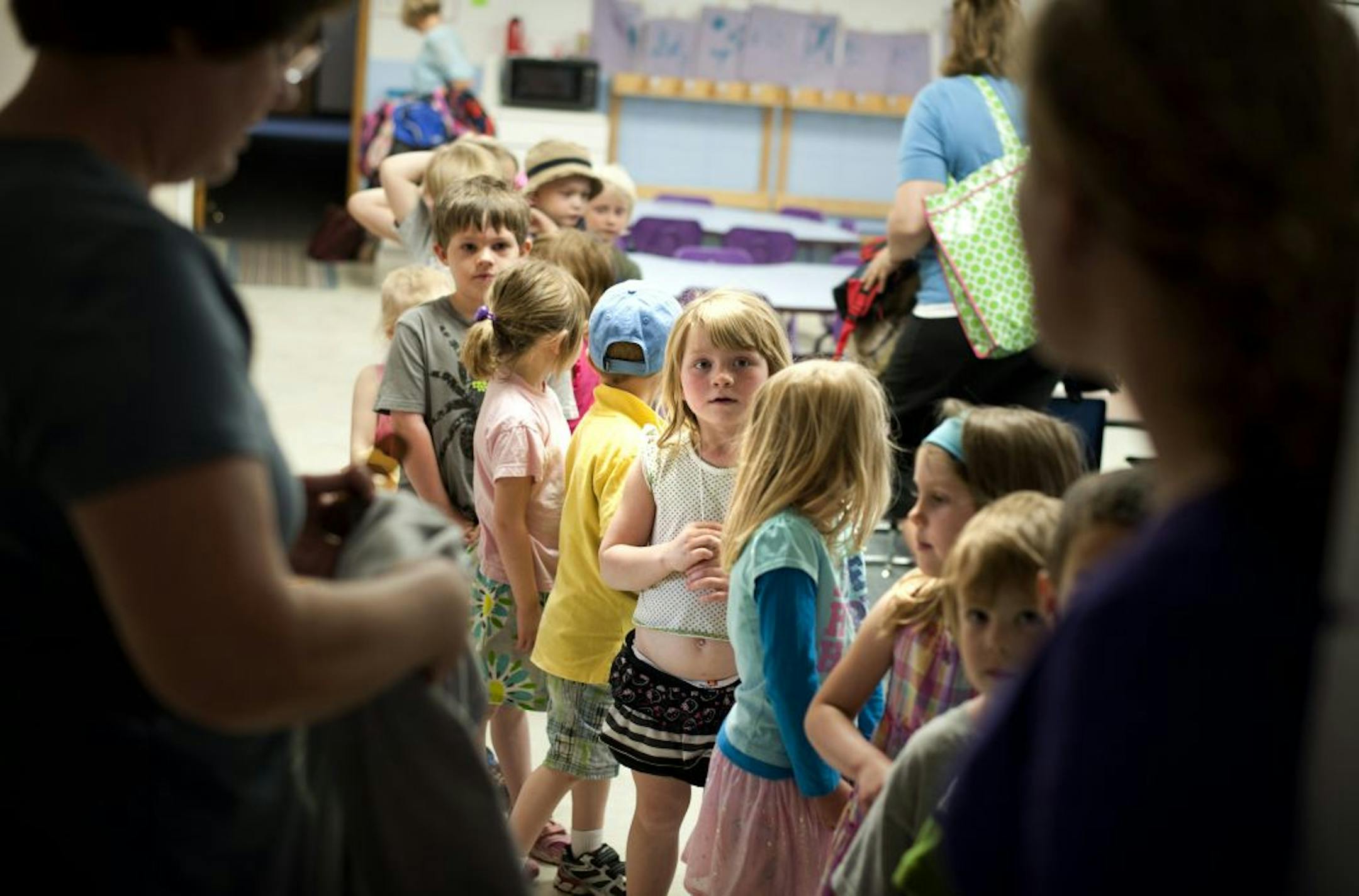 Afton Preschool director Cindy Melzer, left and student teacher Krista Friberg, right had students line up before going outside, Tuesday, May 15, 2012. The preschool is closing down May 24.