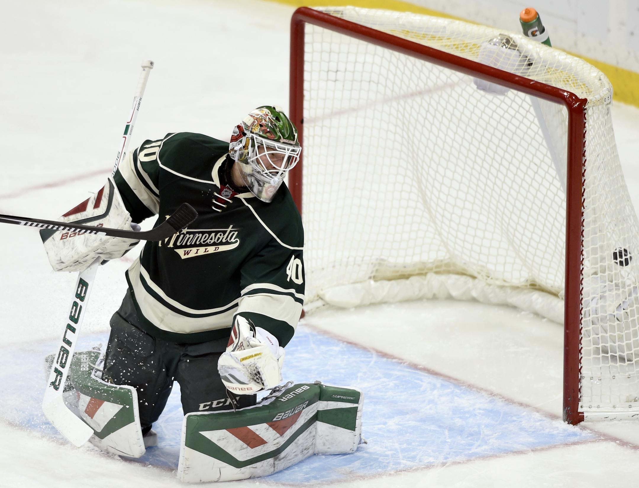 Minnesota Wild goalie Devan Dubnyk (40) watches a shot by Winnipeg Jets right wing Blake Wheeler enter the net for a goal during the first period of an NHL hockey game Friday, Jan. 15, 2016, in St. Paul, Minn. (AP Photo/Hannah Foslien)