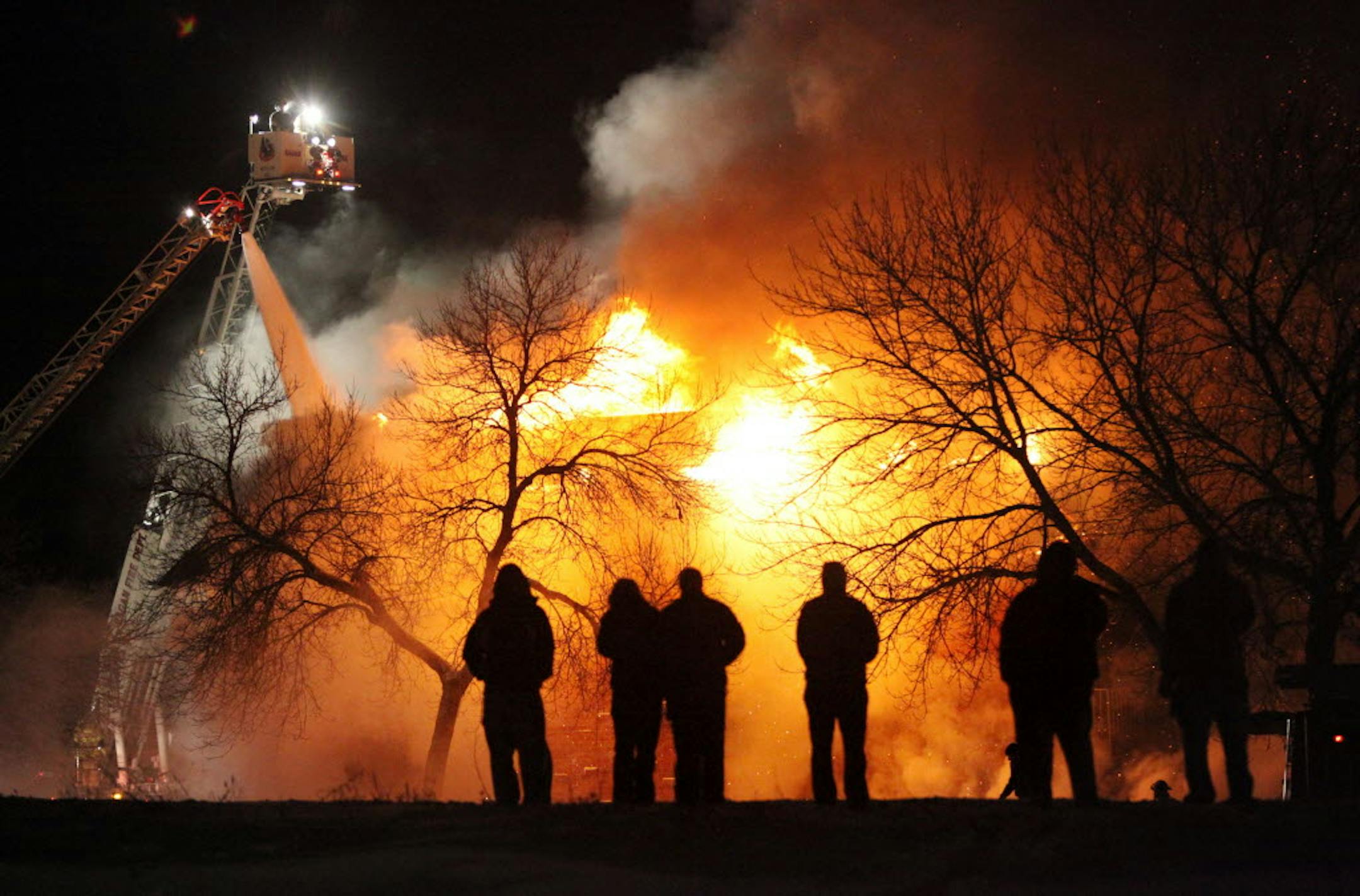 Firefighters battle a four-alarm fire at Burncliff Apartments, 12312 Parkwood Dr., Burnsville, on Monday night.