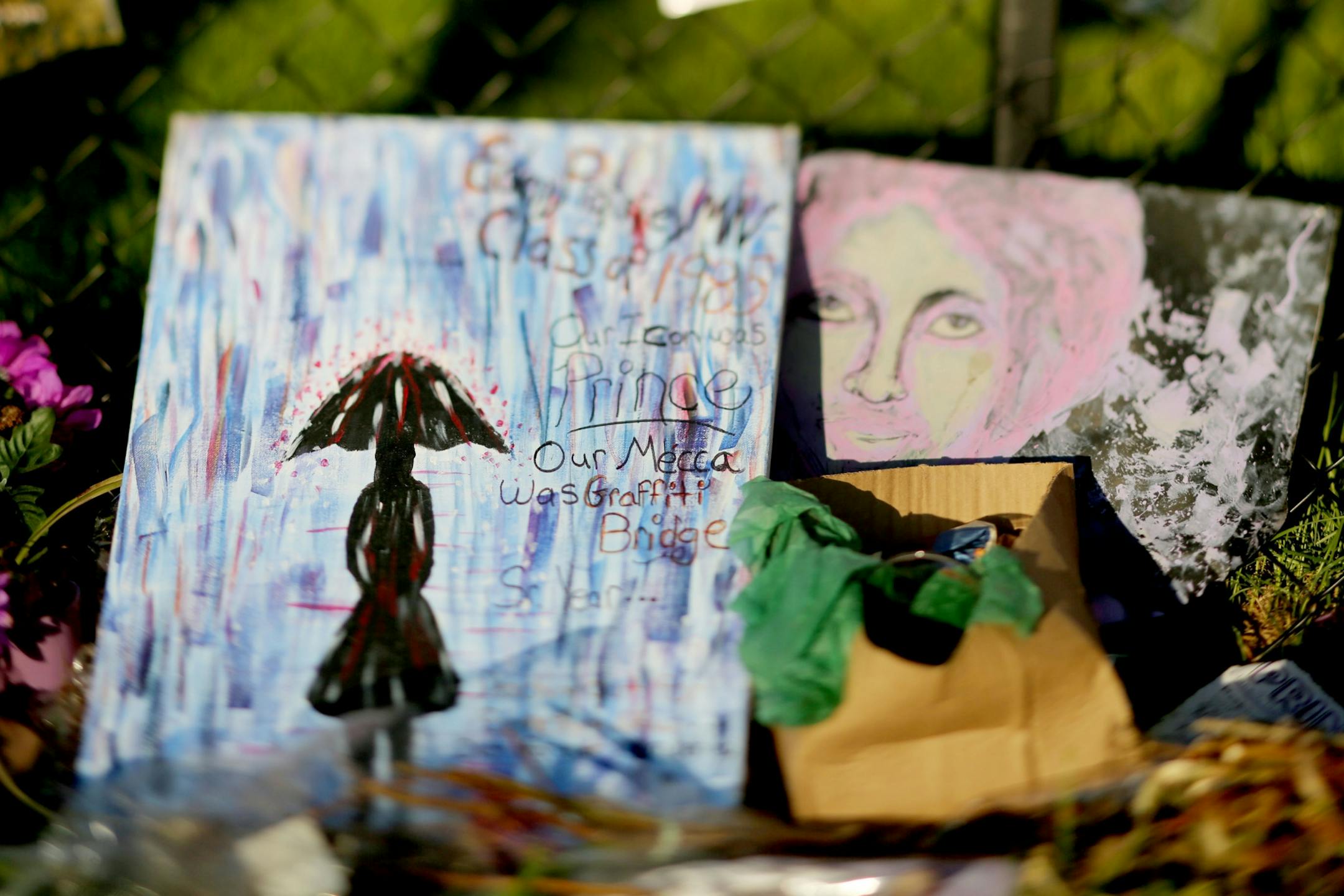 Two paintings left behind as a memento by Prince fans outside Paisley Park Sunday May 15, 2016, in Chanhassen, MN.