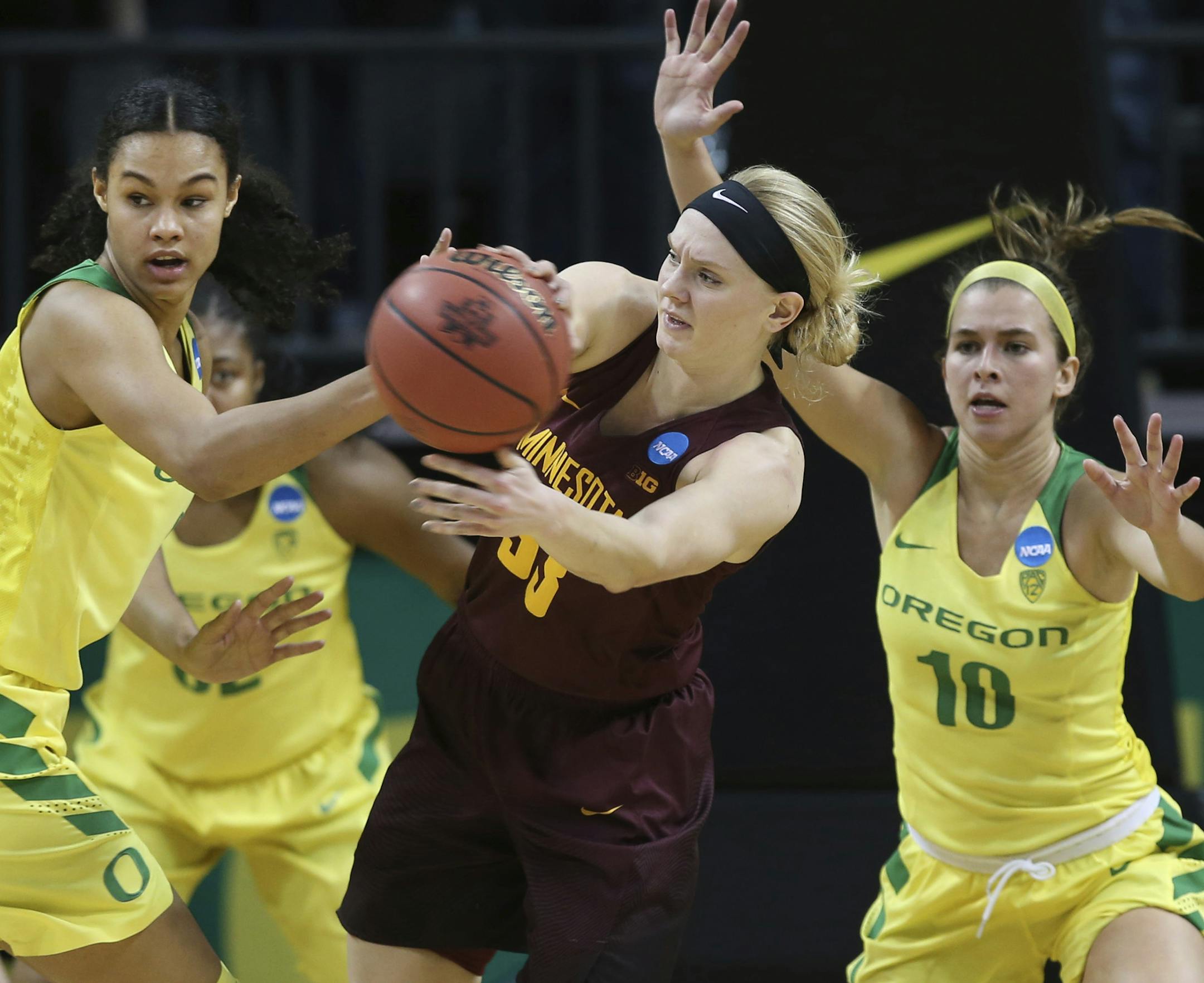 Oregon's Satou Sabally, left, Oti Gildon, center left, and Lexi Bando, right, pressure Minnesota's Carlie Wagner, center, during the second half of their second-round game in the NCAA women's college basketball tournament in Eugene, Ore., Sunday, March 18, 2018. Oregon won 101-73. (AP Photo/Chris Pietsch)