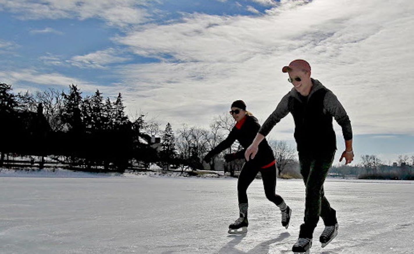 Warm temperatures and a sunny day made for fun ice time for Amie Driessen, left, and Jackson Faith at Lake of the Isles, Monday, January 26, 2015 in Minneapolis, MN. ] (ELIZABETH FLORES/STAR TRIBUNE) ELIZABETH FLORES &#x2022; eflores@startribune.com