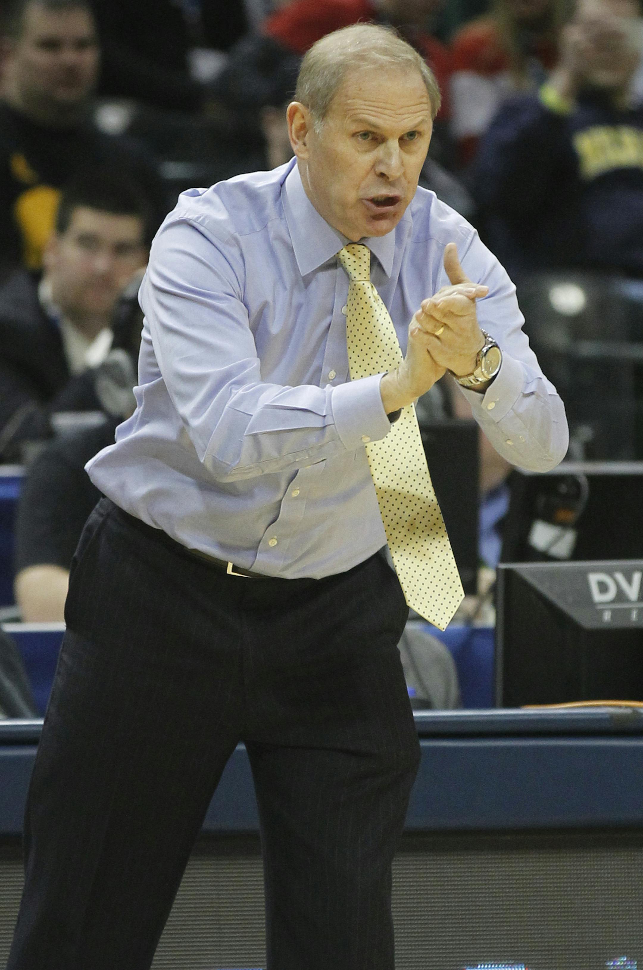 Michigan head coach John Beilein directs his team in the first half of an NCAA college basketball game in the semifinals of the Big Ten Conference tournament Saturday, March 15, 2014, in Indianapolis. (AP Photo/Kiichiro Sato)