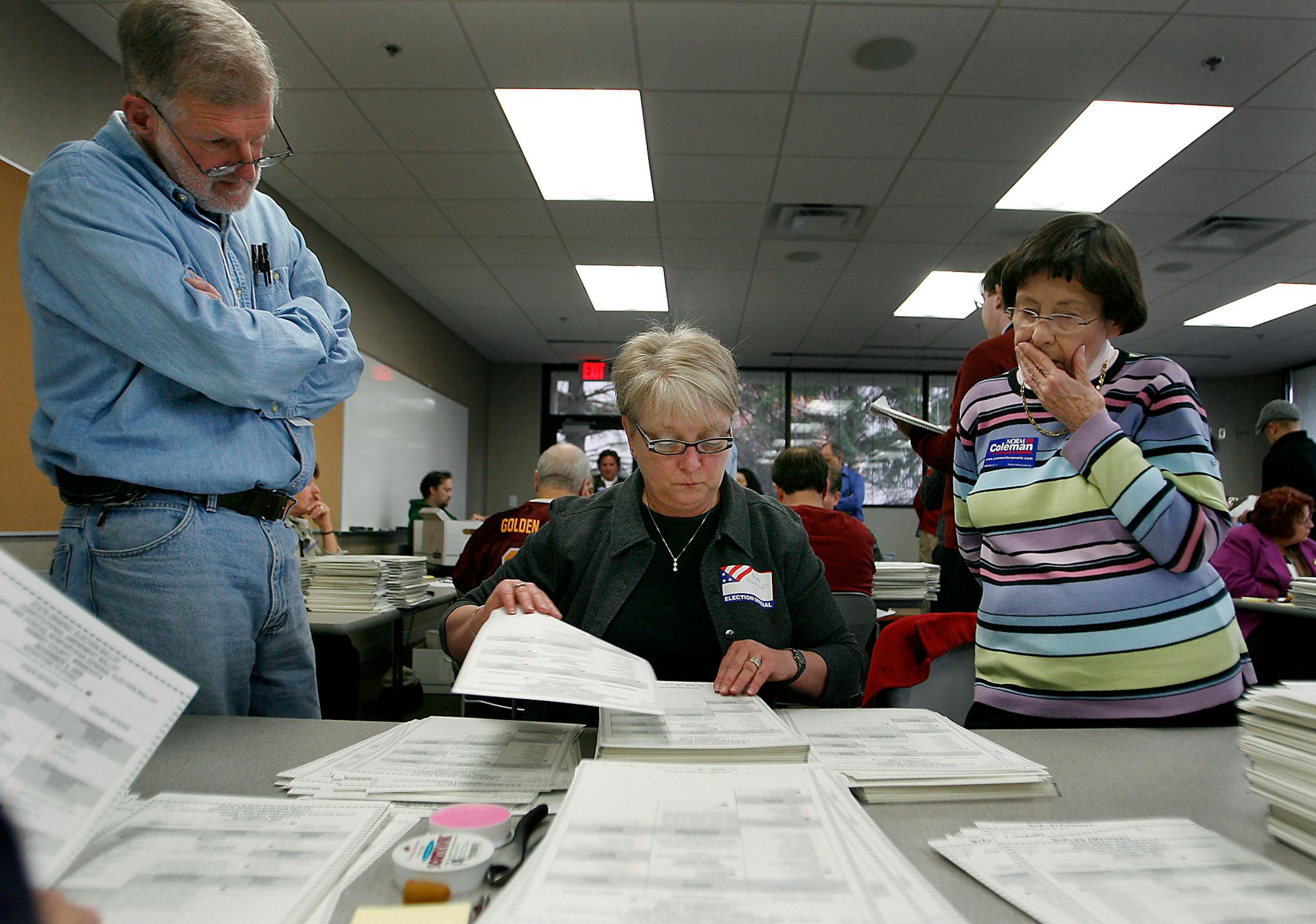 ELIZABETH FLORES eflores@startribune.com November 19, 2008 - St. Paul, MN - Election counter Karen Guilfoile counted ballots as election observers Bill Heaney, representing Franken, left, and Jeannette Wier, representing the Coleman campaign, looked on during the recount process for Ramsey County at the Elections Divisions office.