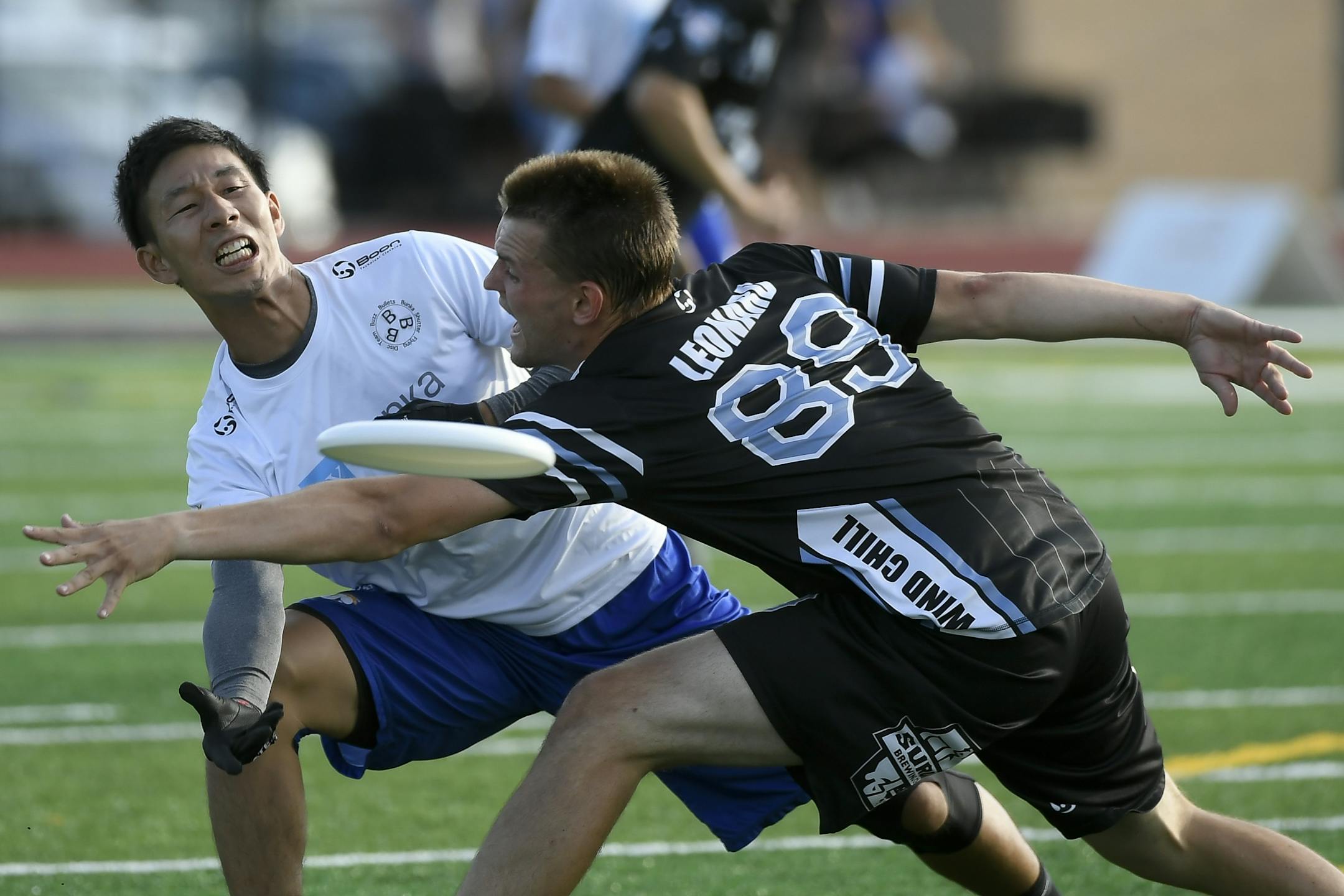 The Buzz Bullets' Masahi Kurono passed the frisbee through the defense of the Minnesota Wind Chill's Isaac Leonard during their match Wednesday night.