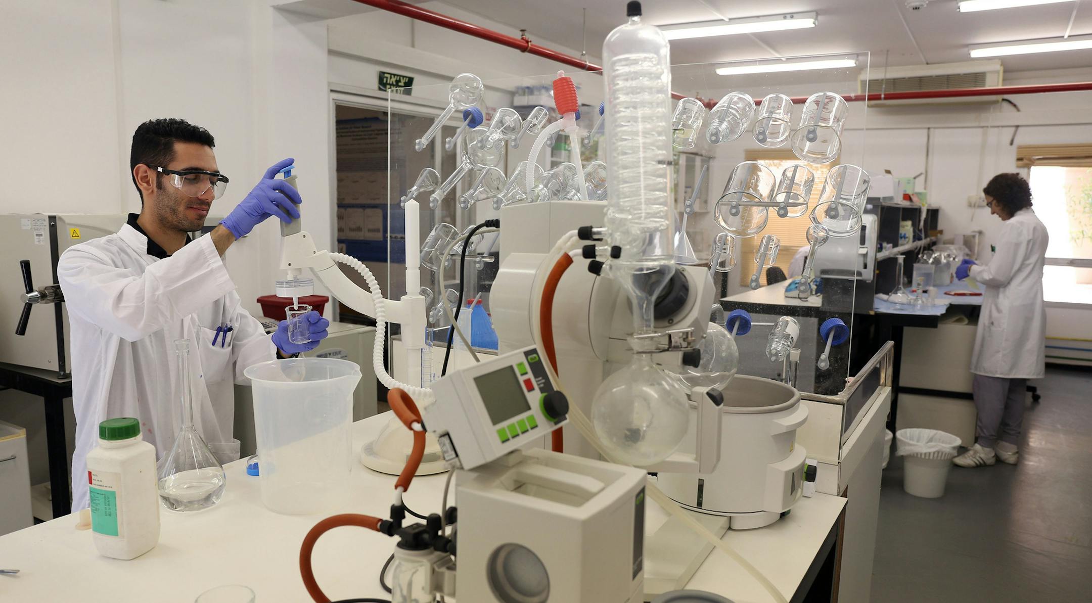 Shai Badalov, left, and Kati Matzkin work in Chris Arnusch's laboratory Monday, June 16, 2014 to create water filters with inkjet printers at Ben-Gurion University in Sede Boker, Israel. (Brian Cassella/Chicago Tribune/TNS)