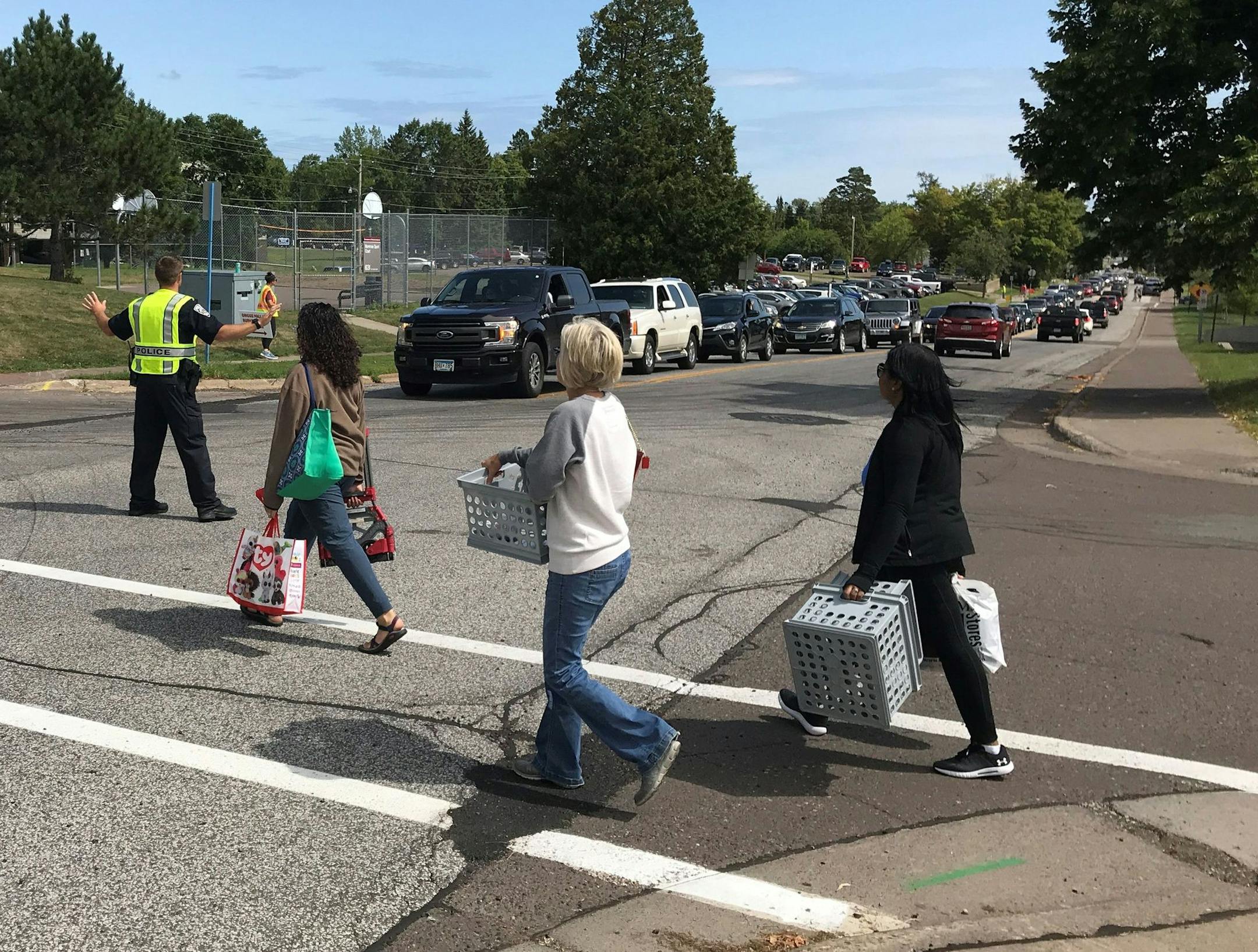 Parents and students navigate campus as cars filled with the same line up for blocks on St. Marie Street during move-in day at UMD on Thursday.