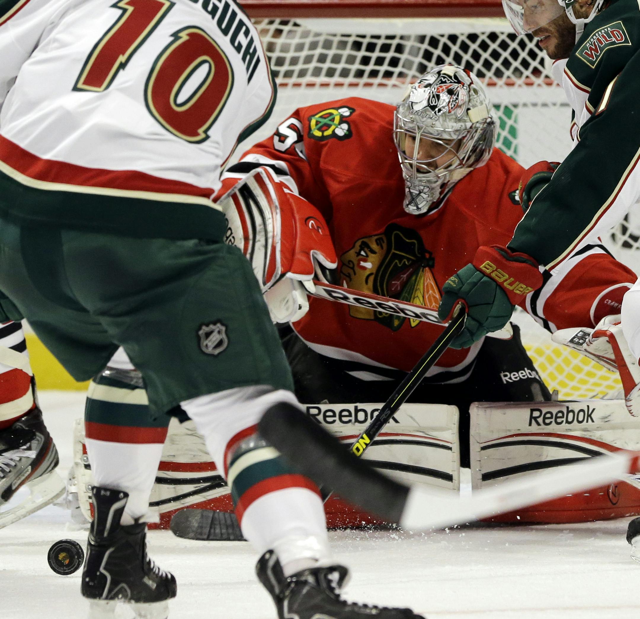 Blackhawks goalie Corey Crawford blocked a shot by the Wild’s Devin Setoguchi during the first period of Thursday night’s game. Crawford made 21 saves in a series-clinching victory.