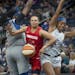 Washington Mystics' Kristi Oliver gets tangled between Lynx' Sylvia Fowles, left, and Lexi Brown to draw a foul during the third quarter as the Lynx t