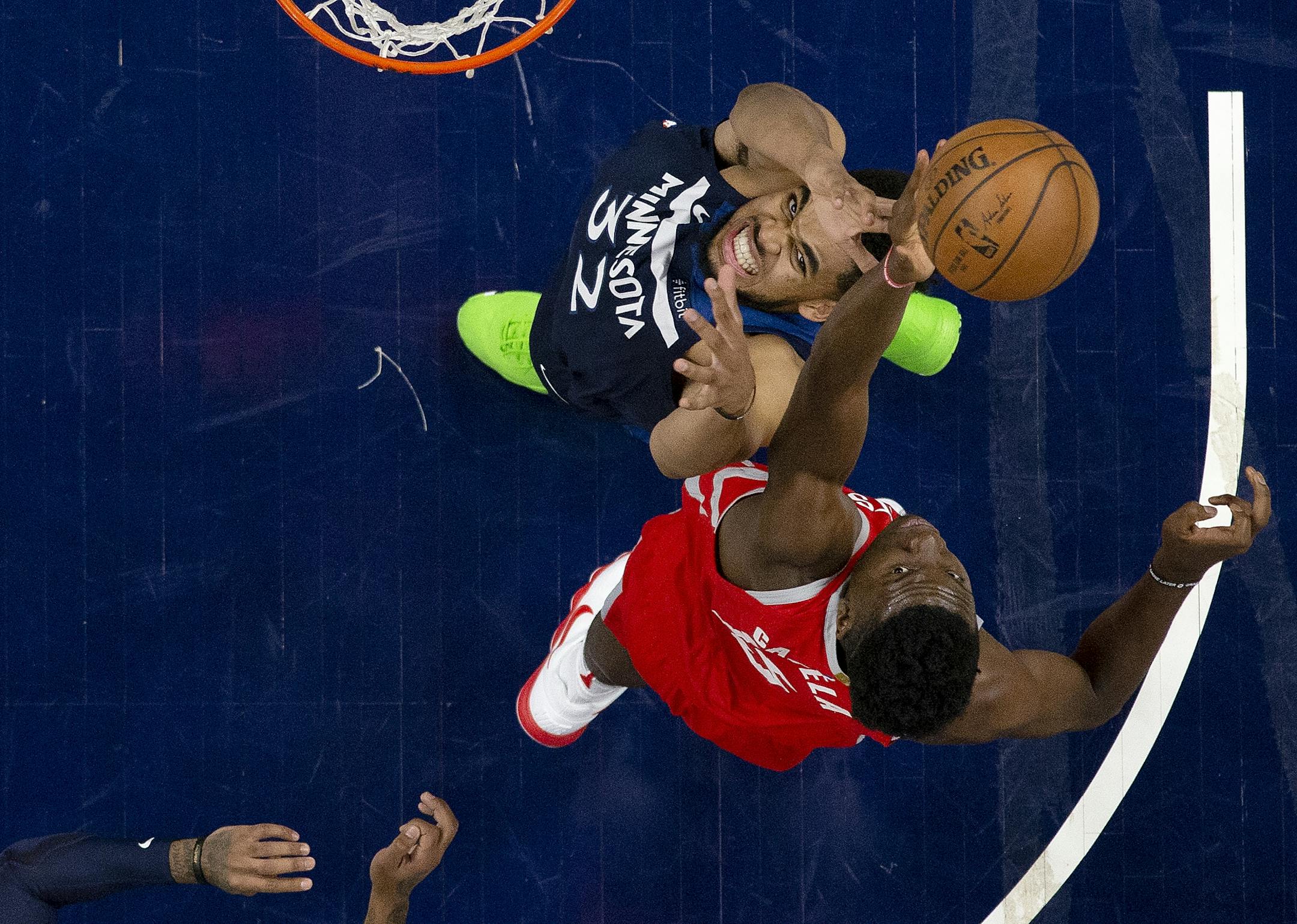 Karl-Anthony Towns (32) and Clint Capela (15) fought for a rebound in the second half.