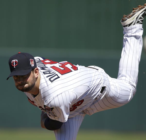 Minnesota Twins pitcher Scott Diamond delivers a warm-up throw in the first inning of an exhibition baseball game against the Boston Red Sox, Saturday