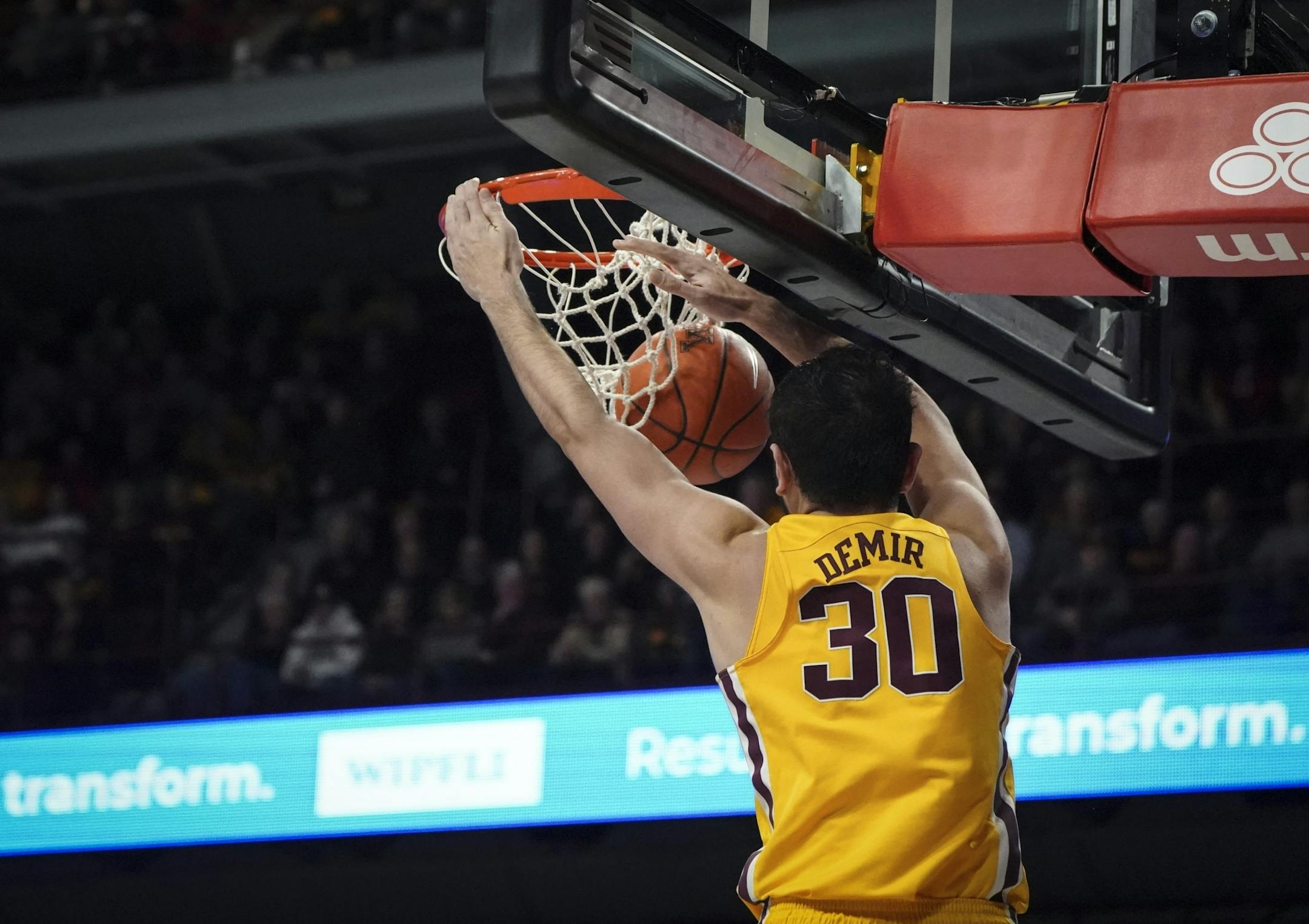 Minnesota Gophers forward Alihan Demir (30) dunked the ball in the first half.