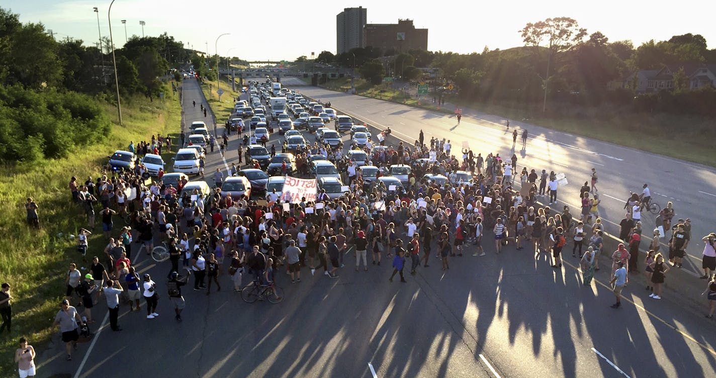 FILE - In this July 9, 2016 file photo, marchers block part of Interstate 94 in St. Paul, Minn., during a protest sparked by the recent police killings of black men in Minnesota and Louisiana. The killing of Philando Castile by a Minnesota police officer during a traffic stop last week tore open wounds that hadn't yet healed in Minnesota's black community from a previous officer-involved death last year. (Glen Stubbe/Star Tribune via AP, File)