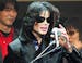 **FILE** Michael Jackson delivers his speech to fans during an event "Fan Appreciation Day" in Tokyo on March 9, 2007. Jackson is "a little bit under 