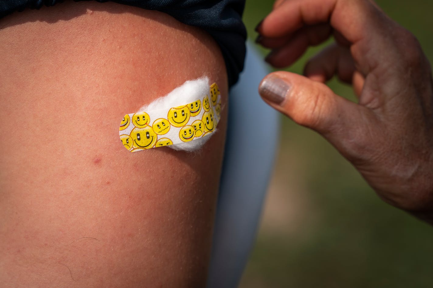 Mason Nadolney got a bandage on his arm after receiving his second Pfizer vaccine shot from a nurse with Carver County during a mobile vaccine event at Chanhassen High School. ] LEILA NAVIDI • leila.navidi@startribune.com