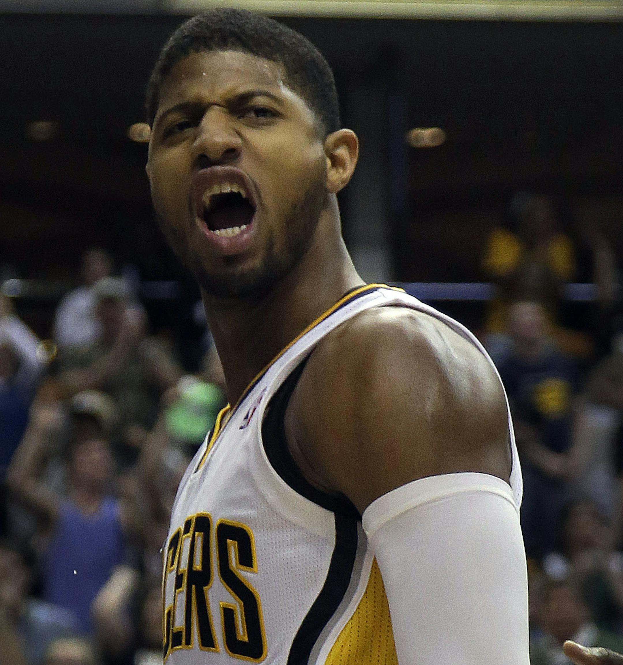 Indiana Pacers forward Paul George (24) reacts after scoring on a dunk during the second half of an NBA basketball game against the Philadelphia 76ers in Indianapolis, Monday, March 17, 2014. The Pacers won 99-90. (AP Photo/AJ Mast) ORG XMIT: INAM105