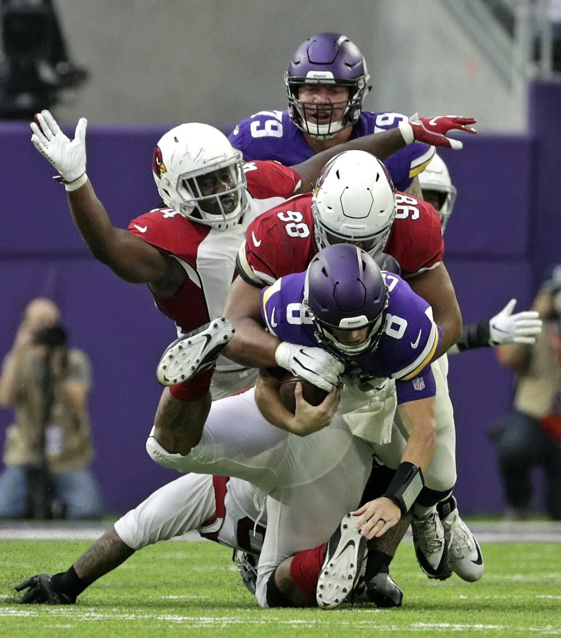 Vikings quarterback Kirk Cousins is sacked by Corey Peters in the 2nd quarter.