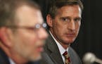 Former Syracuse athletic director Mark Coyle listens to University of Minnesota President Eric Kaler, left, as Coyle was introduced as Minnesota athle