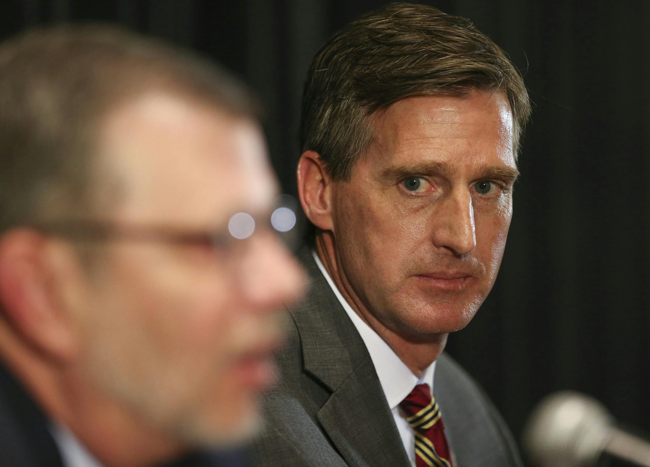 Former Syracuse athletic director Mark Coyle listens to University of Minnesota President Eric Kaler, left, as Coyle was introduced as Minnesota athletic director, Wednesday, May 11, 2016, in Minneapolis. (Jeff Wheeler/Star Tribune via AP) ORG XMIT: MIN2016051119345943