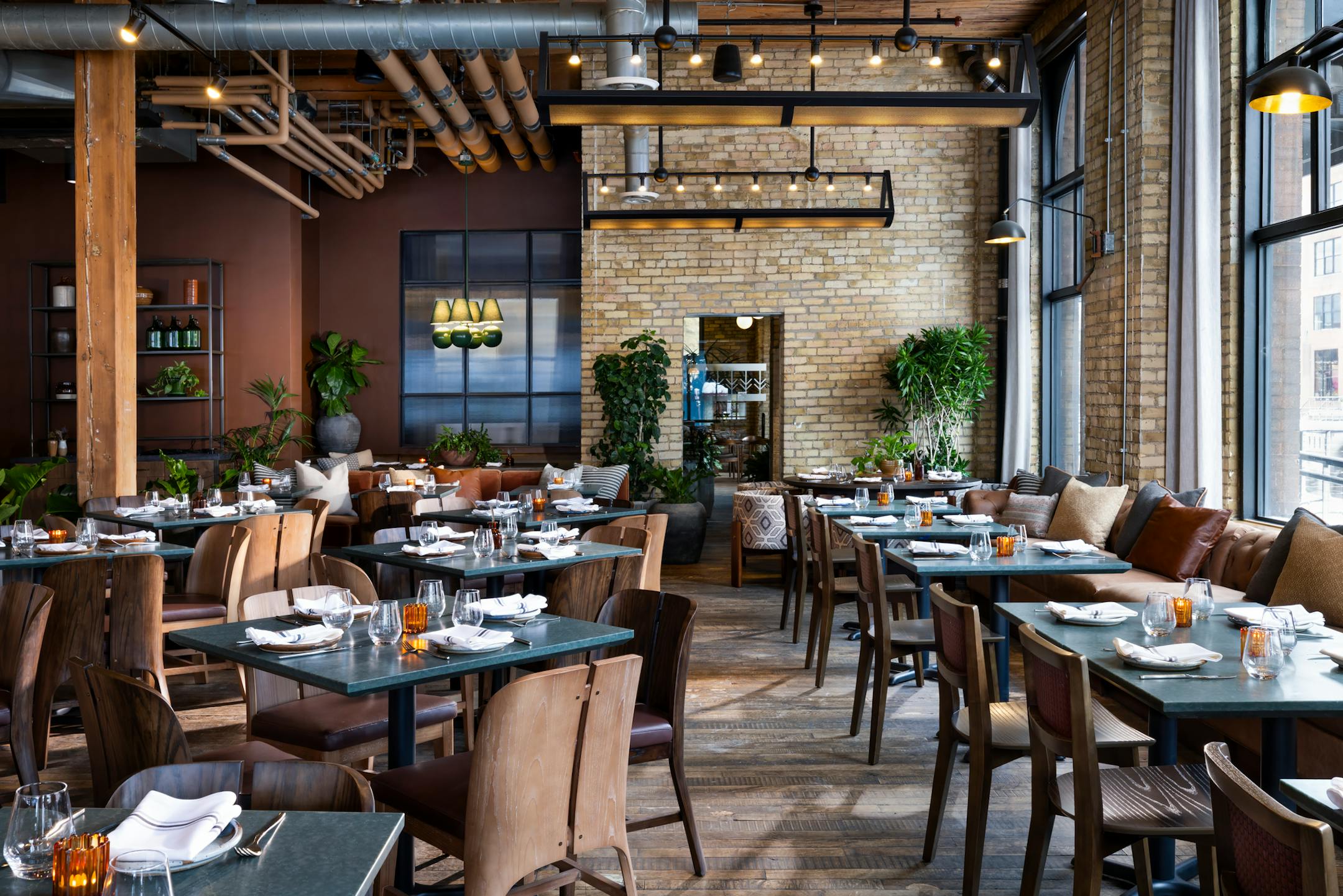 Tullibee's dining room with new chairs and tables in the exposed brick and rough hewn wood framed room.