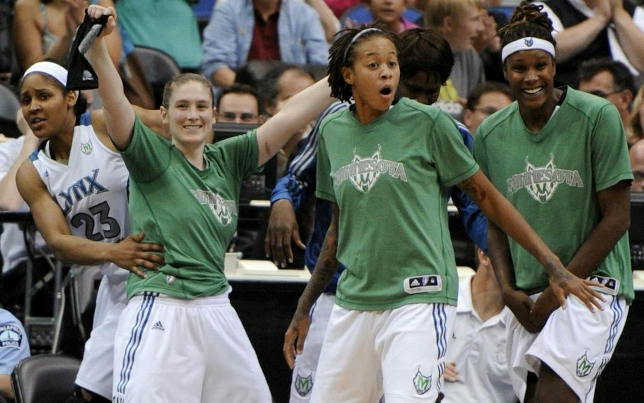 Minnesota Lynx's Maya Moore, Lindsay Whalen, Seimone Augustus and Rebekkah Brunson, from left, celebrate on the bench during the fourth quarter of a WNBA basketball game against the Washington Mystics in Minneapolis on Tuesday, Aug. 30, 2011. The Lynx won 73-56.