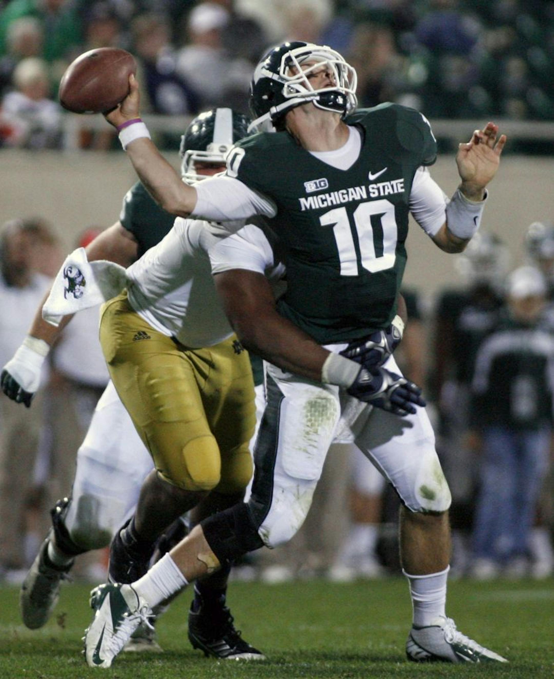 Michigan State quarterback Andrew Maxwell is hit by Notre Dame's T.J. Jones.