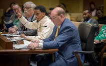 Sen. Omar Fateh, center, discusses his Uber bill during a Senate commerce committee hearing on April 16. To his left is Uber lobbyist Joel Carlson.