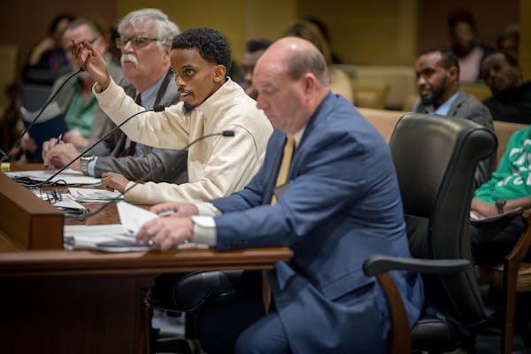 Sen. Omar Fateh, center, discusses his Uber bill during a Senate commerce committee hearing on April 16. To his left is Uber lobbyist Joel Carlson.