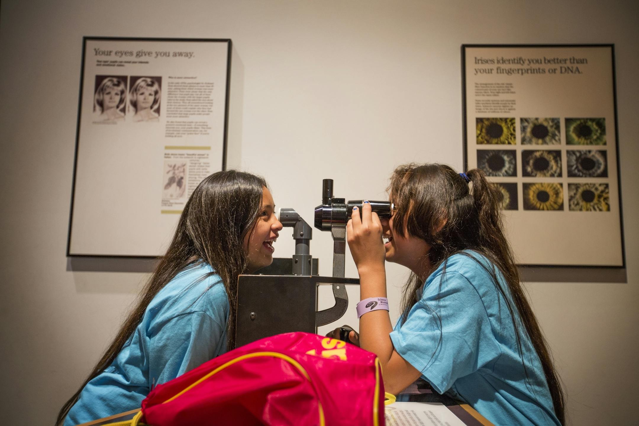 Dayzah Wiyaka, left, 11, and Mckynzie Hollow, 12, both of Minneapolis, explore their own eyes through a microscope at the Science Museum of Minnesota in St. Paul on Tuesday, June 30, 2015.