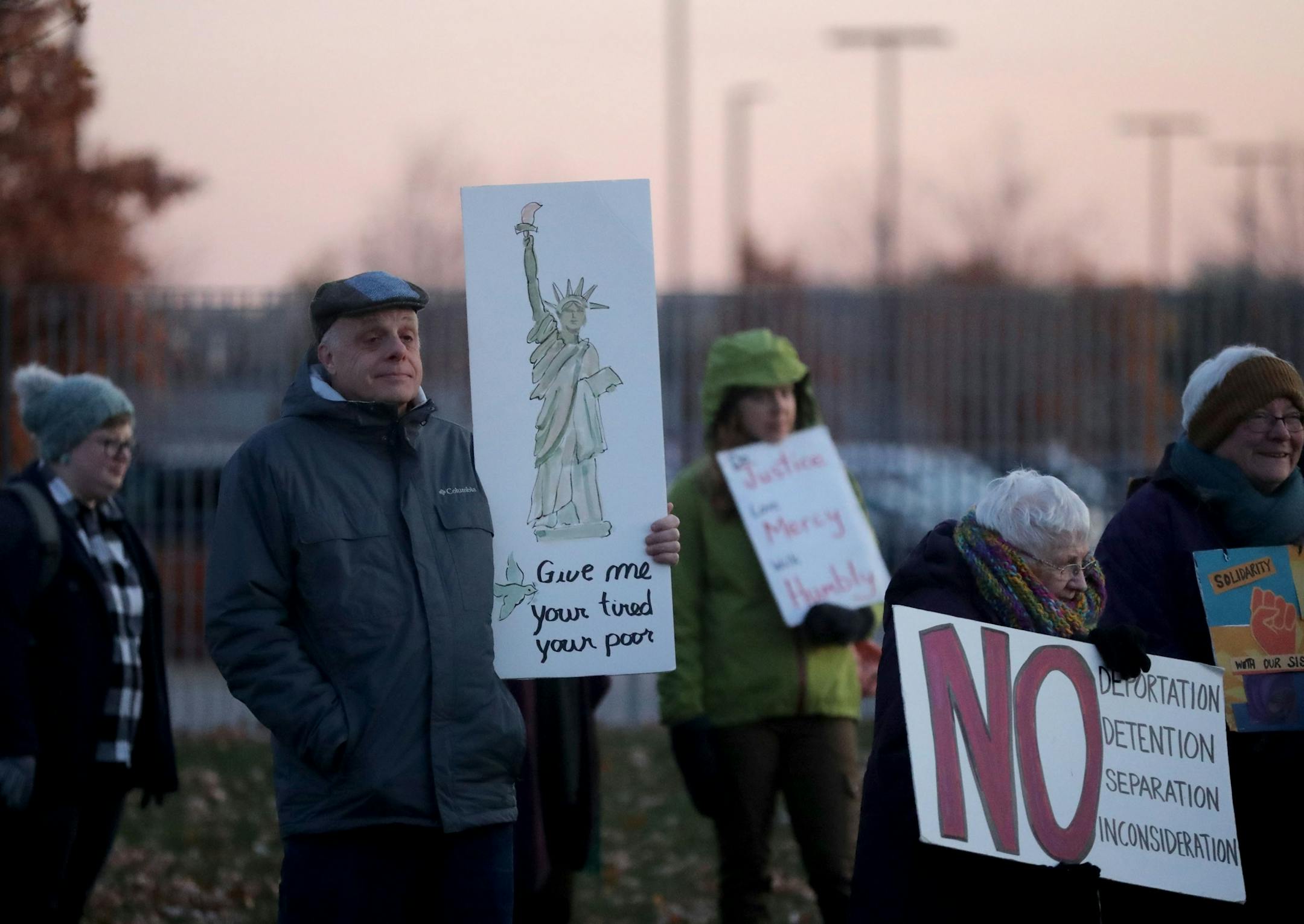 Greg Olson of Eden Prairie, left to right, and Sally Sommers of Minneapolis, who are regular Tuesday protestors, stand outside the Whipple Federal Building Tuesday, Oct. 29, 2019, in St. Paul, MN. Clergy and protestors gathered for a service and communion outside the Whipple Federal Building and to protest the naming of the building after the Episcopal bishop because deportations and other actions at the courthouse are in opposition to the beliefs of the Episcopal church, they stated.