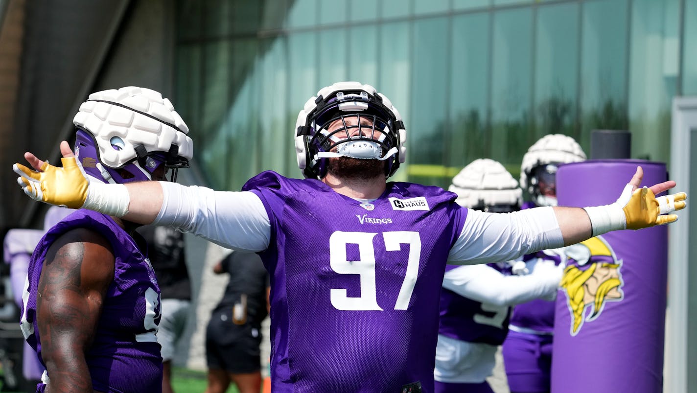 Minnesota Vikings defensive tackle Harrison Phillips (97) stretches out his arm to embrace a cool breeze during training camp Tuesday, Aug. 2, 2022 at the TCO Performance Center in Eagan, Minn. ] ANTHONY SOUFFLE • anthony.souffle@startribune.com