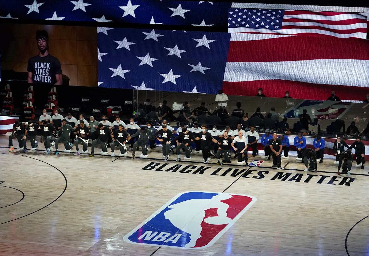 Dallas Mavericks kneel in to pay tribute to the Black Lives Matter movement prior to their NBA first round playoff game against the Los Angeles Clippers Sunday, Aug. 30, 2020, in Lake Buena Vista, Fla. (AP Photo/Ashley Landis)first half of an NBA first round playoff game Sunday, Aug. 30, 2020, in Lake Buena Vista, Fla. (AP Photo/Ashley Landis)