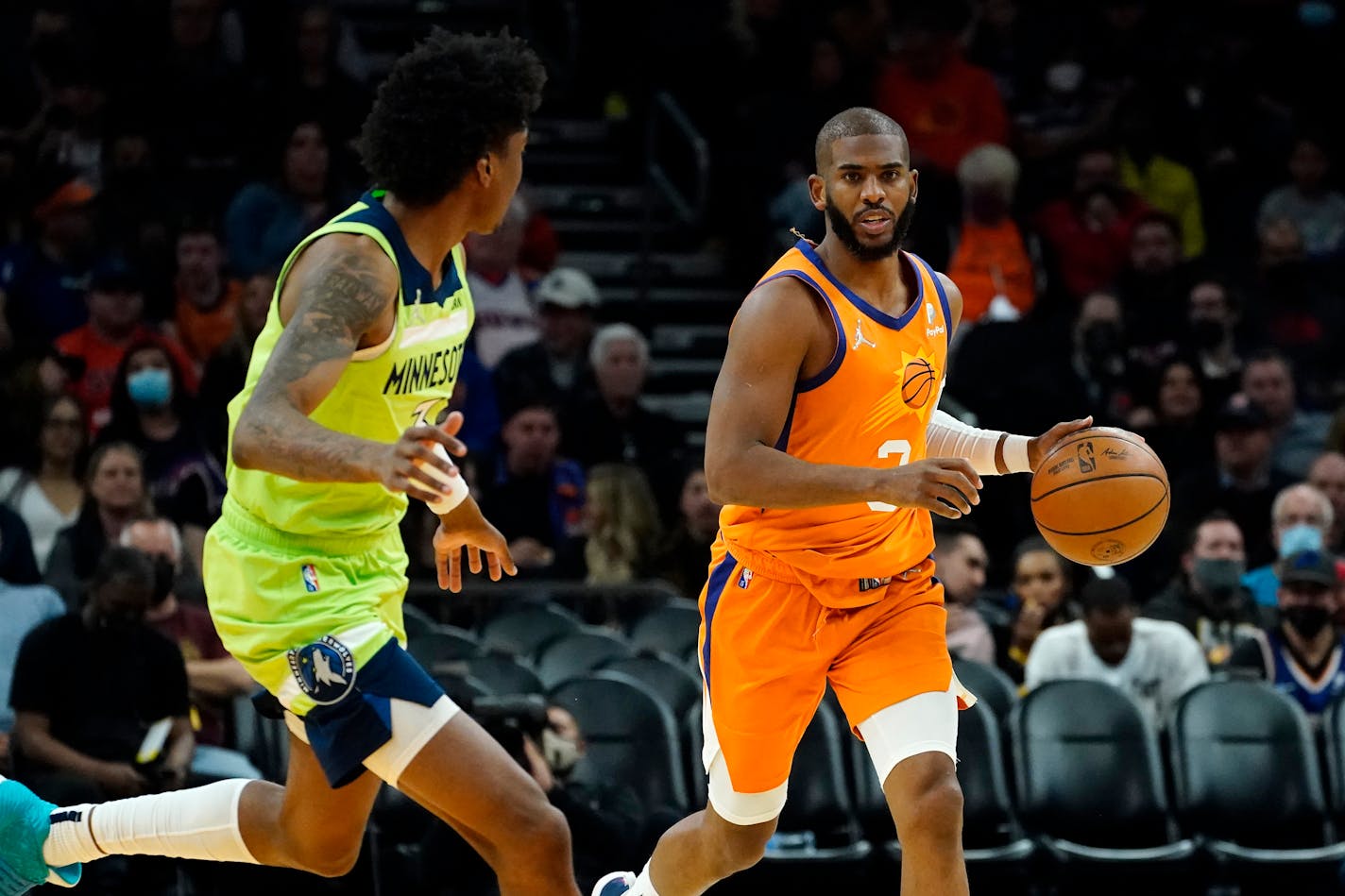 Phoenix Suns guard Chris Paul moves the ball up court as Timberwolves forward Jaden McDaniels defends during the second half Friday.