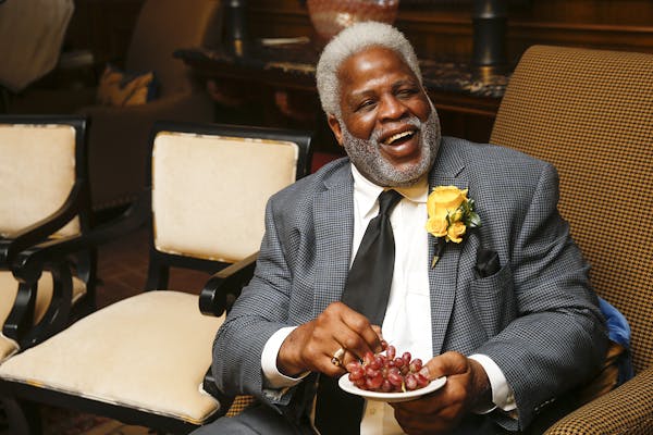 In this Wednesday, Jan. 10, 2018 photo, Hall of Fame football player Earl Campbell smiles as he eats grapes a friend brought him during the Fifth Annu