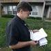 Aaron Belenky reads a letter from election officials while standing in front of his apartment in Overland Park, Kan., Wednesday, Aug. 14, 2013.