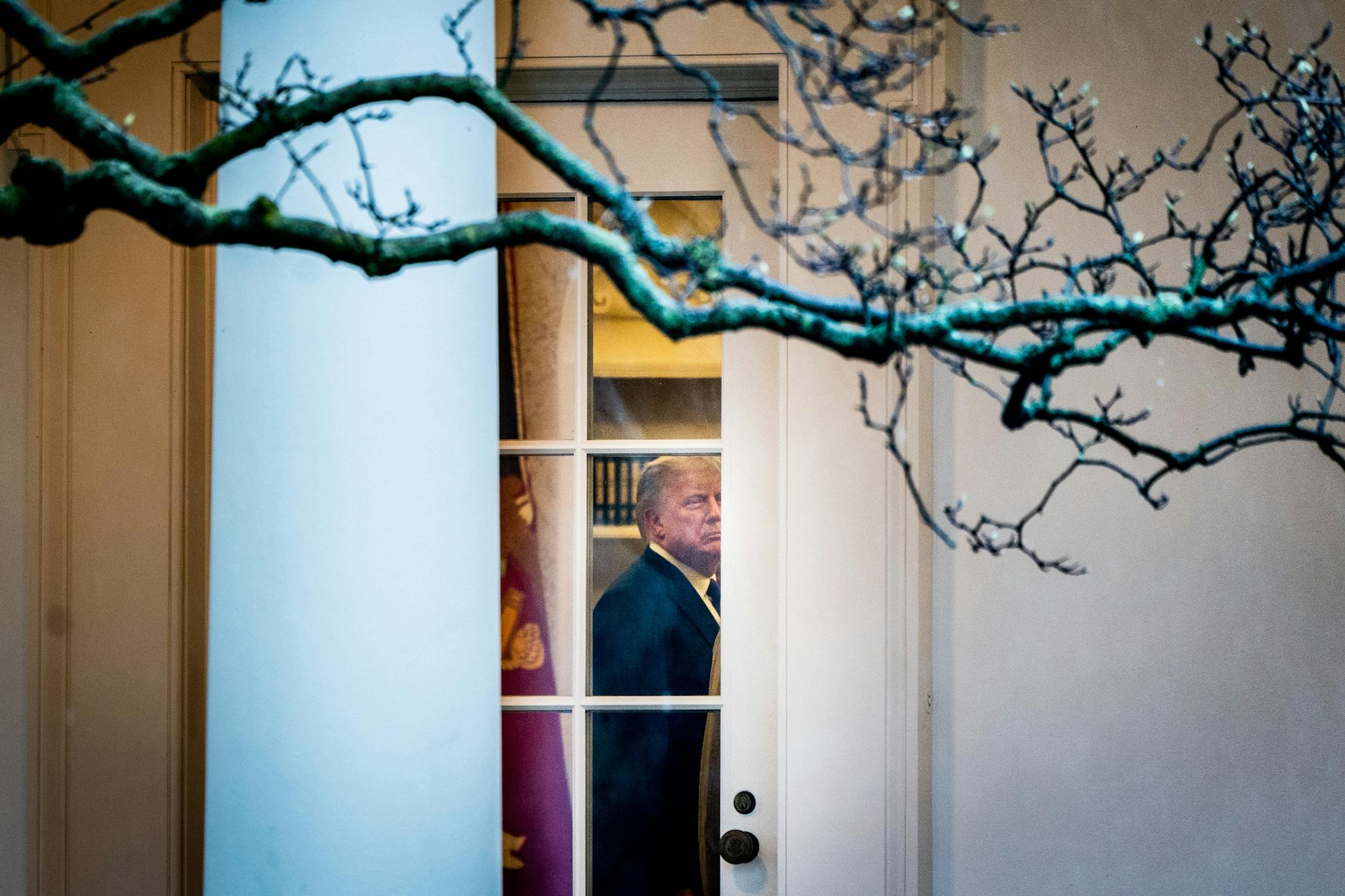 President Donald Trump talks with advisors in the Oval Office of the White House on Wednesday. Trump earlier attended a National Veterans Day Observance ceremony at Arlington National Cemetery in Arlington, Va.