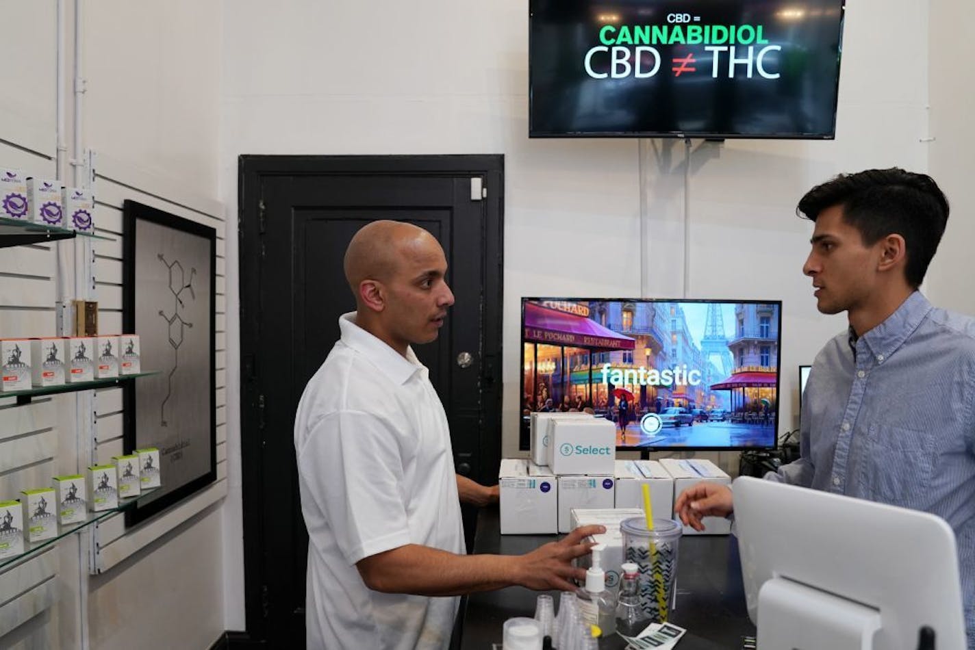 Giovan Jenkins, left, president of Nothing But Hemp, talked with Andrés Alvarez, store manager in Uptown. The company takes steps to regulate its products despite little government oversight.