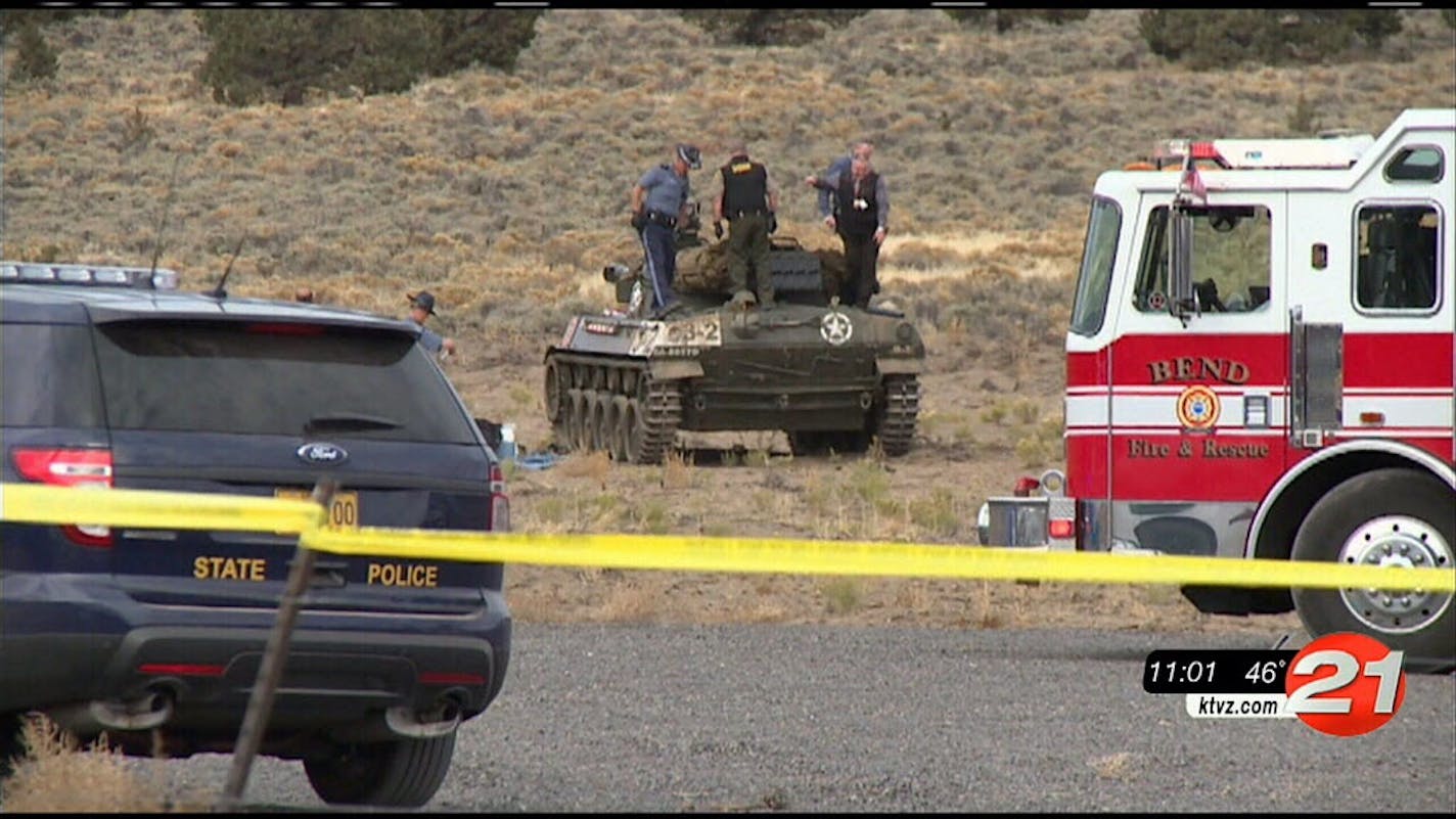 This Tuesday, Oct. 27, 2015 image made from video by KTVZ-TV shows investigators inspecting the scene of an explosion inside a World War II-era tank at a public firing range that left two people dead near Bend, Ore.