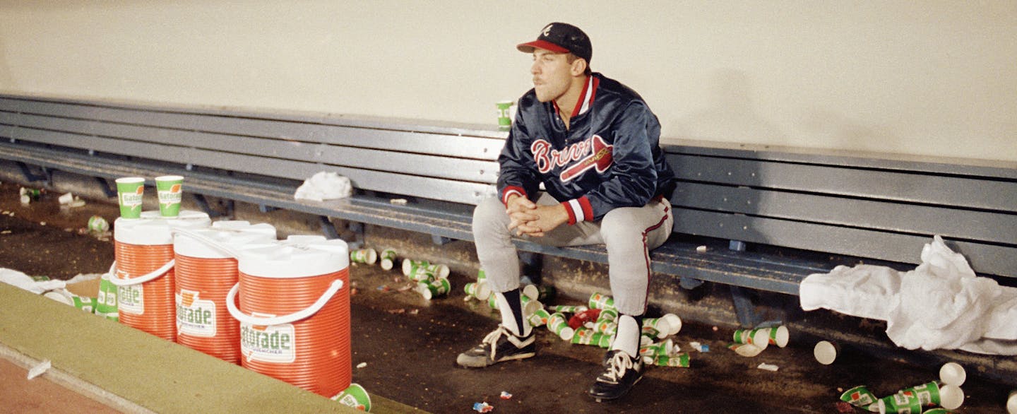 Atlanta Braves pitcher John Smoltz sits all alone in the Braves dugout after the Braves lost 1-0, in the 10th inning, Oct. 27, 1991 to the Minnesota Twins in game seven of the World Series. Smoltz was the starting pitcher. (AP Photo/Bill Waugh) ORG XMIT: APHS78898