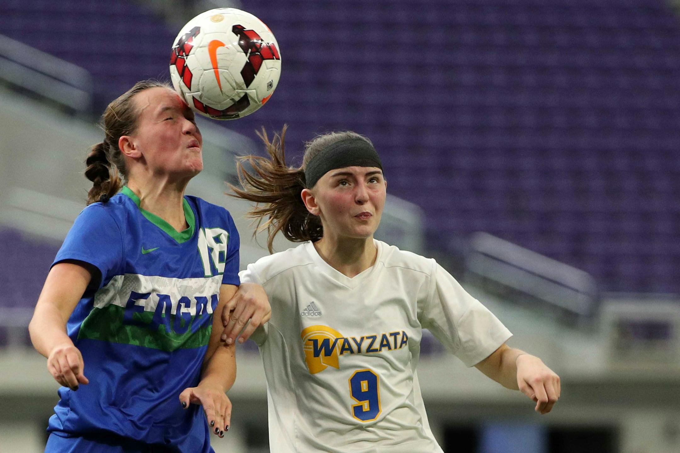 Eagan High School defender Lauryn Roszak (18) and Wayzata High School forward Samantha Dietrick (9) both went up to head the ball in the first half. ] ANTHONY SOUFFLE ï anthony.souffle@startribune.com Game action from a Class 2A girls' soccer semifinal game between Eagan High School and Wayzata High School Tuesday, Oct. 31, 2017 at US Bank Stadium in Minneapolis.