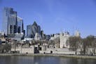 A deserted Tower of London normally packed with tourists and visitors with the backdrop of the City of London, Tuesday, March 24, 2020. Britain's Prim