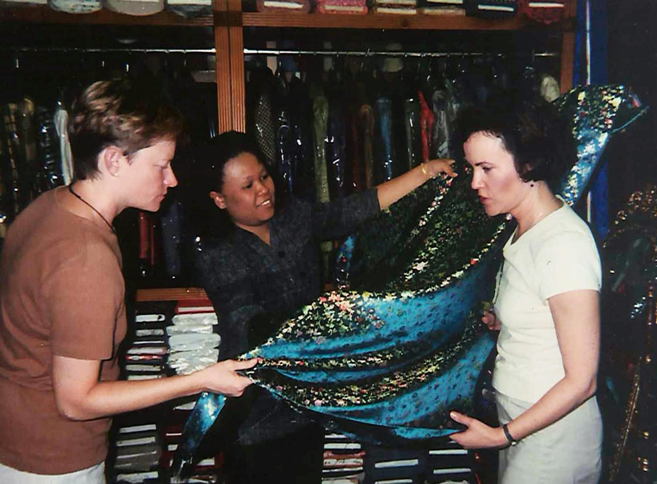 The author's wife, Kathy, and her friend, Martha Klasing of Rockville, Md., take a close look at the fabric Kathy's chosen for her custom-tailored traditional silk dress. ] Subject:†Photos for 'Bangkok'†story / image #8 Photo by: Peter Mandel, (401) 831-5227