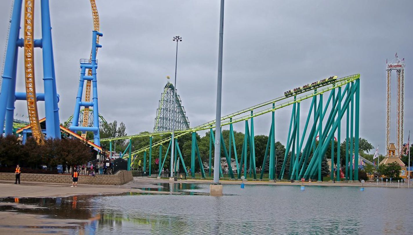 Valleyfair enthusiasts ride the Wild Thing roller coaster near a flooded parking lot, Wednesday, June 25, 2014 in Shakopee. The parking lot and three rides were closed due to flooding; however, the rest of the park remained open.