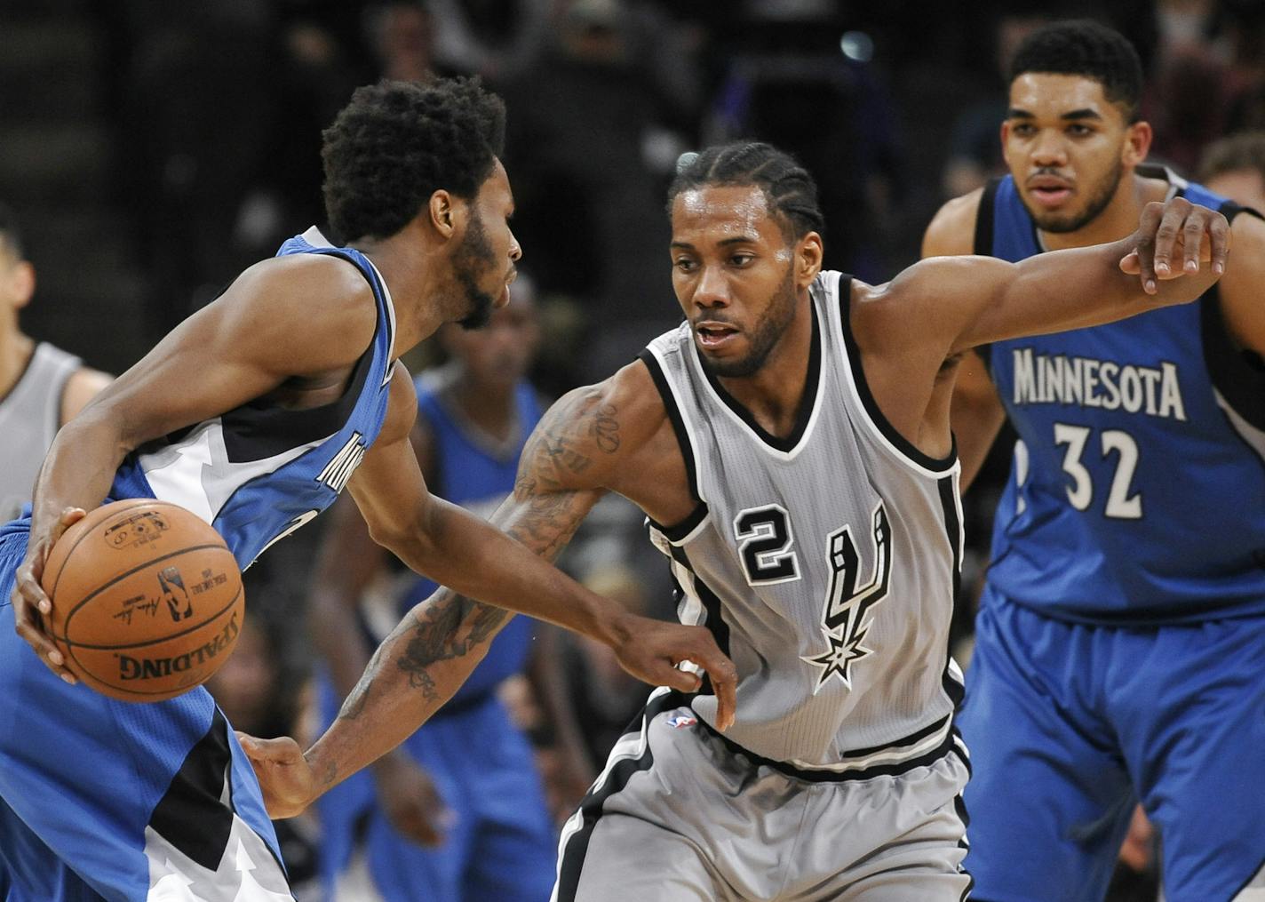 Spurs forward Kawhi Leonard (2) guarded Timberwolves forward Andrew Wiggins during the second half Saturday. San Antonio won 97-90 in overtime.